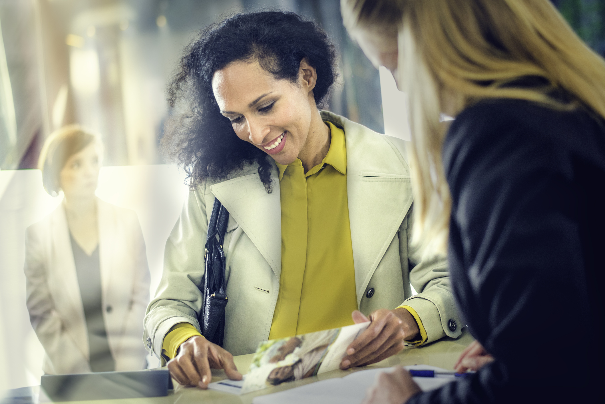 Lady holding print marketing materials.